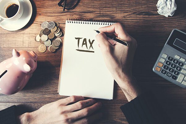 a person writing on a notepad